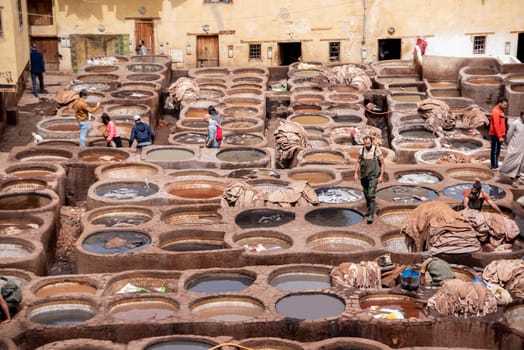 FES, MOROCCO - ARIL 10, 2023 - Famous tannery in the medina of Fes, where leather is being processed for generations, Morocco