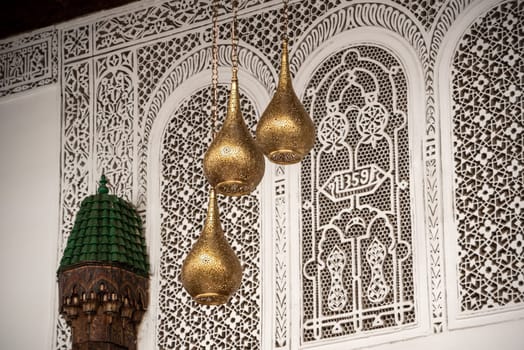MARRAKECH, MOROCCO - ARIL 10, 2023 - Three brass lamps in a typical palace in Marakesh, Morocco