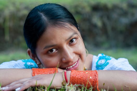 closeup of a very happy young indian woman with a true and natural smile posing for the camera. High quality photo