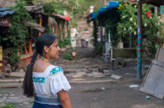 young indigenous woman acting as a tourist guide in a native town in latin america. High quality photo