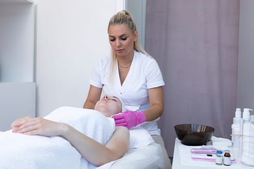 Dermatologist Clears Skin Of Neck And Face Of Young Woman Before Beauty Procedure, Applying Alginate Mask In Spa Center. Patient Getting Needle Mesotherapy, Flatly Skincare. Horizontal Plane.