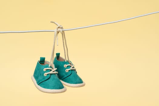 As baby shoes gently sway on the clothesline, they become a heartwarming symbol of a newborn's