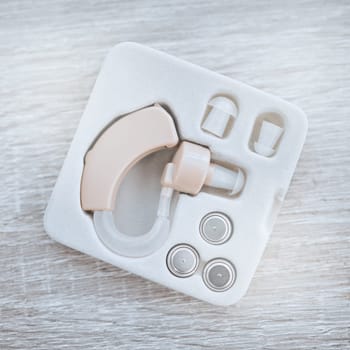 Hearing aid, healthcare and box for ear device with disability, medical equipment or sound. Audiology, deafness and technology for audio, wellness or medicine industry with modern listening accessory.