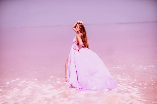 Woman pink salt lake. Against the backdrop of a pink salt lake, a woman in a long pink dress takes a leisurely stroll along the white, salty shore, capturing a wanderlust moment