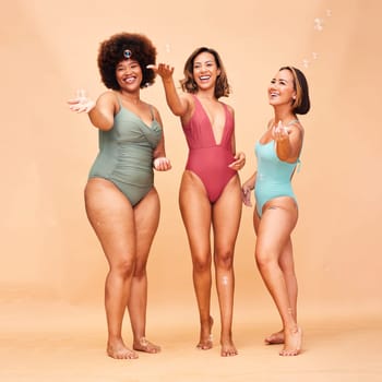 Summer, party and portrait of women with bubbles or inclusion of friends in studio background or swimming fashion. Body positivity, diversity and group of people for fun swimsuit beauty and skincare.