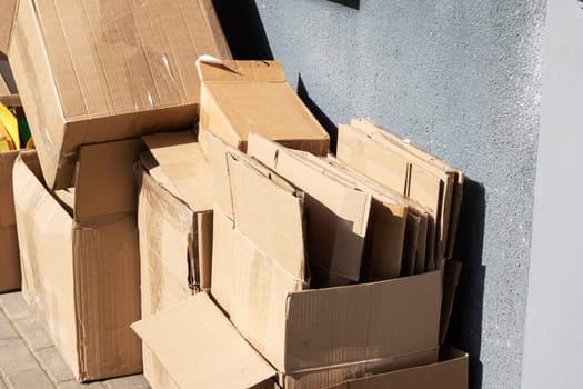 Empty cardboard boxes after moving close up in sunlight