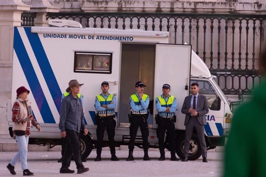 14 november 2023, Lisbon, Portugal - group of Police officer standing on praca do commerce and guard and protect - telephoto shot