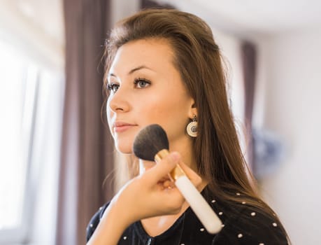 Closeup of a makeup artist applying makeup