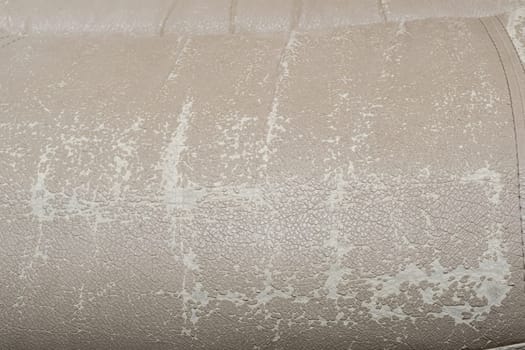 Defects on a white leather sofa. Damaged to leather furniture. Close up of damaged white leather soft tufted furniture. Bad quality leather