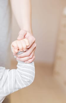 Concept of love and family. hands of mother and baby closeup.