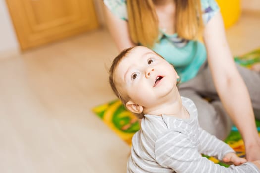 Little cute baby boy plays in his room