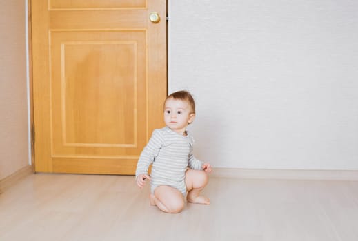 Little cute baby boy plays in his room