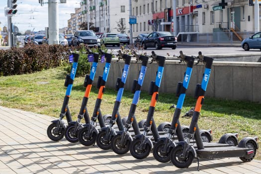 Belarus, Minsk - 20 september, 2023: A row of rental electric scooters on the pavement