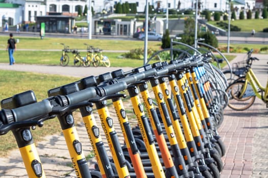 Belarus, Minsk - 20 september, 2023: A row of rental electric scooters on the pavement