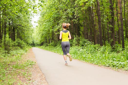 young fitness woman runner running on trail.