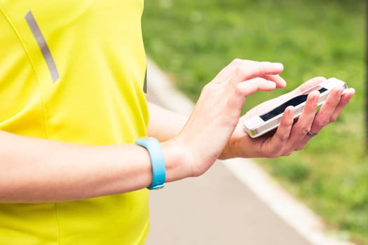 Woman checking fitness and health tracking wearable device.