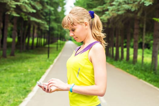 Woman checking fitness and health tracking wearable device.