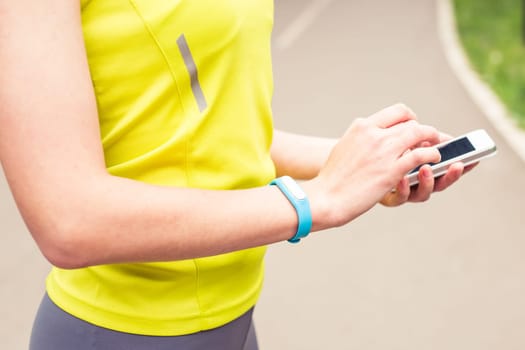 Hand wearing a fitness tracking armband indoors