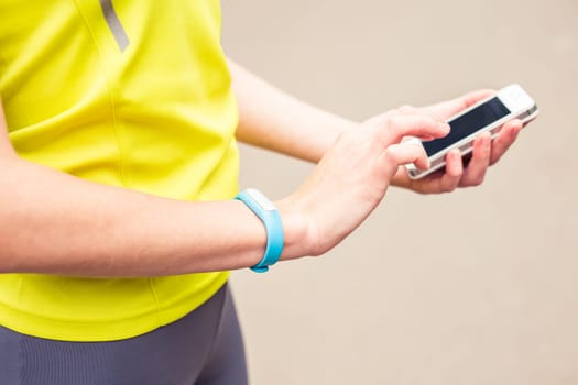 Hand wearing a fitness tracking armband indoors