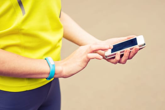 Woman checking fitness and health tracking wearable device.