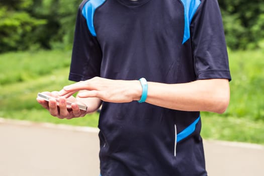 Hand wearing a fitness tracking armband indoors