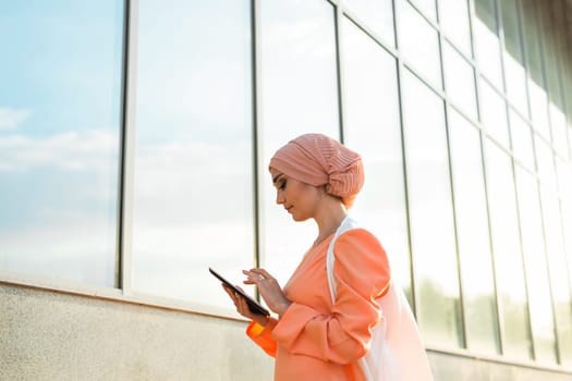 Portrait of an Arab businesswoman in hijab holding a tablet