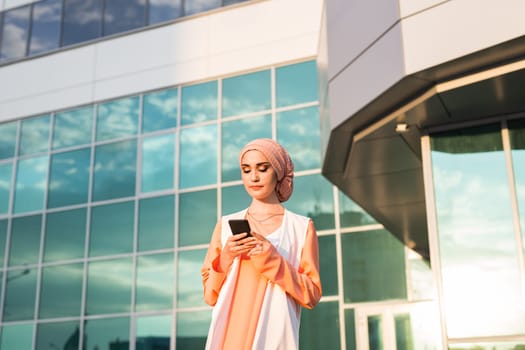 Muslim woman using phone. businesswoman in hijab holding smartphone