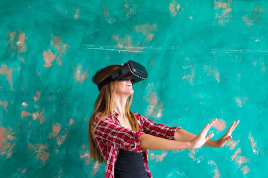 Beautiful young woman playing game in virtual reality glasses.