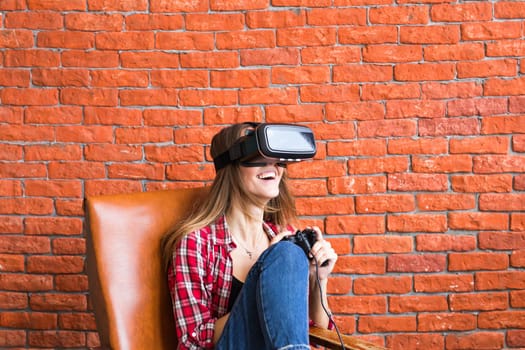 Beautiful young woman playing game in virtual reality glasses.