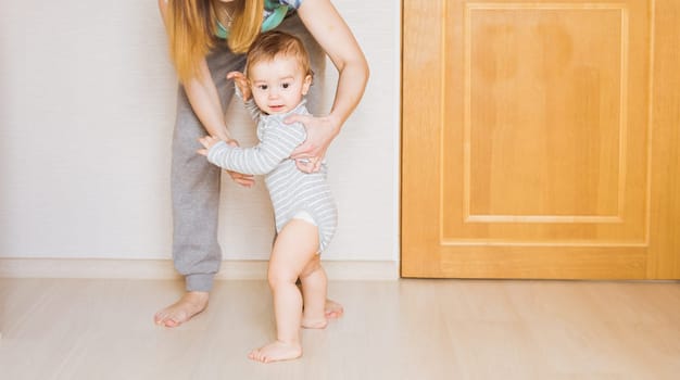 little child baby smiling making first steps.