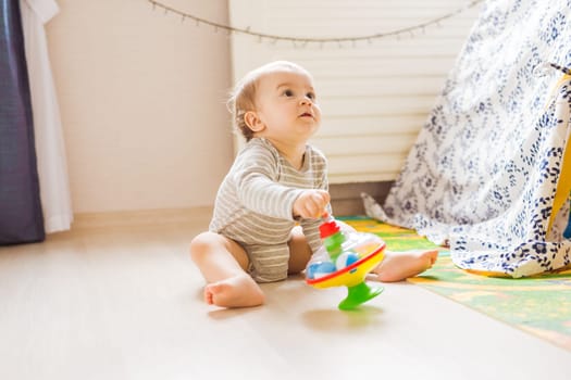 funny baby boy kid playing with toy