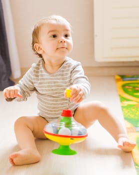 funny baby boy kid playing with toy