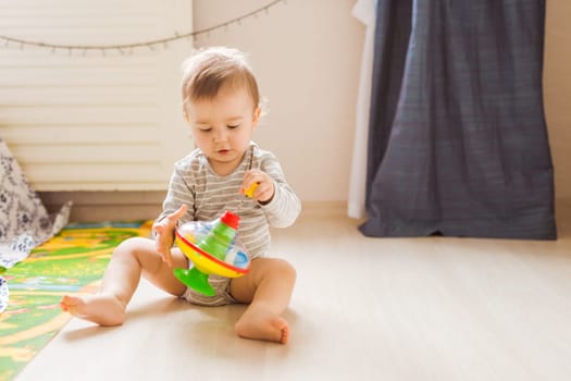 funny baby boy kid playing with toy