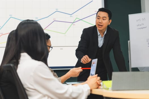 Successful businessman presenting his financial plan and data analyst with confident. group of executive editor focusing on his performance intentionally. Office Conference room meeting. Intellectual.