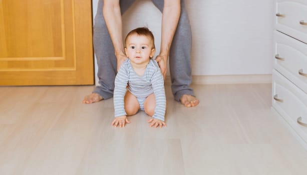 Happy crawling baby boy with his mother