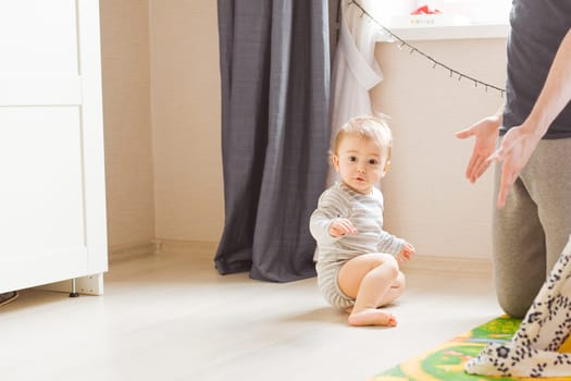 Happy father and baby little son at home