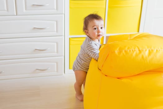 child and toddler concept - curious baby in the room.