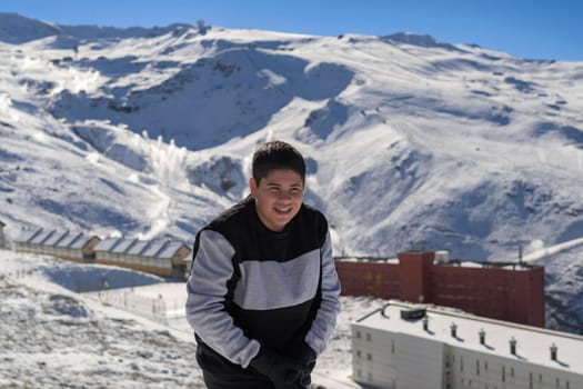 young latin guy with cold,playing in the snow,ski resort sierra nevada,granada,granada,spain,