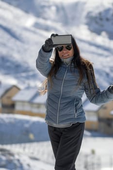 Selfie of a happy lady looking at camera with big smile in winter season.