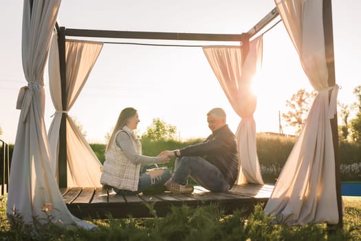 Happy pregnant couple in autumn or spring nature.