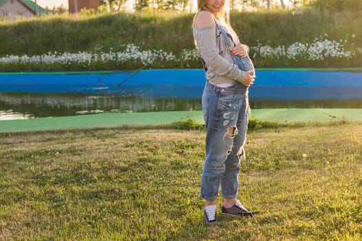 young happy pregnant woman relaxing and enjoying life in autumn nature.