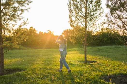 young happy pregnant woman relaxing and enjoying life in autumn nature.