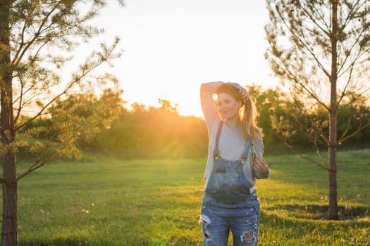 young happy pregnant woman relaxing and enjoying life in autumn nature.