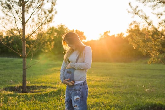 young happy pregnant woman relaxing and enjoying life in autumn nature.