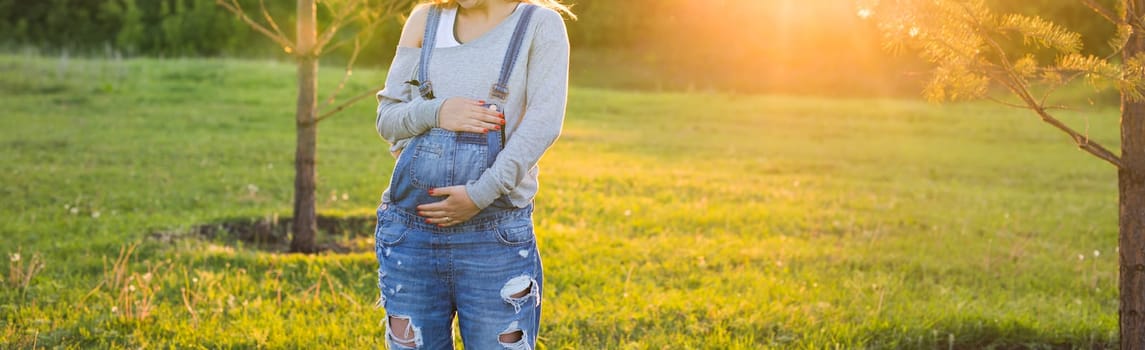 young happy pregnant woman relaxing and enjoying life in autumn nature.