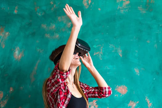 Smile happy woman getting experience using VR-headset glasses of virtual reality at home much gesticulating hands, asian beauty