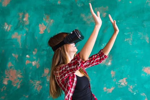 Smile happy woman getting experience using VR-headset glasses of virtual reality at home much gesticulating hands, asian beauty