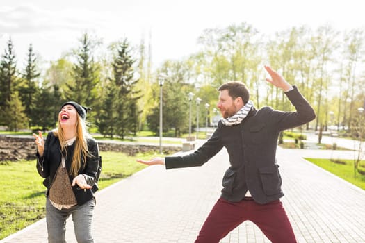 Young happy couple laughing. beautiful young couple fooling around in the park