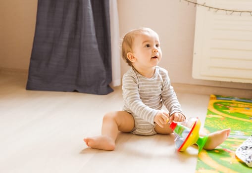 Cute caucasian baby boy in the bedroom