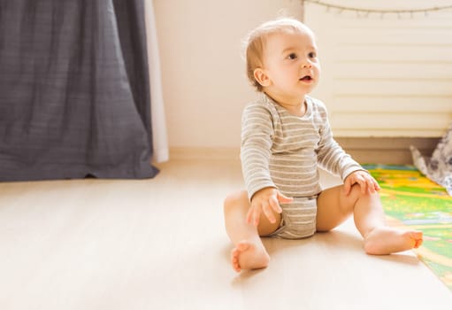 Cute caucasian baby boy in the bedroom